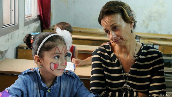 teacher with child in classroom Copyright: UNICEF 
